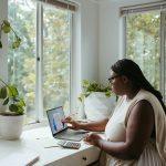 Detroit remote work trends August 2025 showing laptop and city skyline