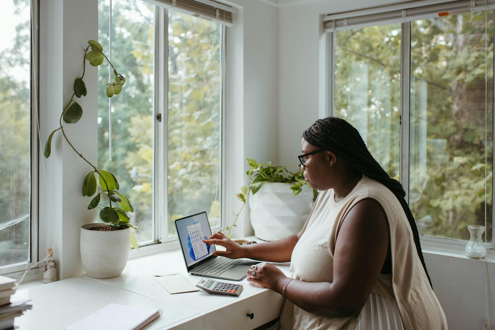 Detroit remote work trends August 2025 showing laptop and city skyline