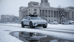 An autonomous vehicle testing unit driving near Michigan Central Station in Detroit